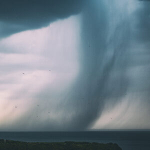 Stormy sky and rain over ocean